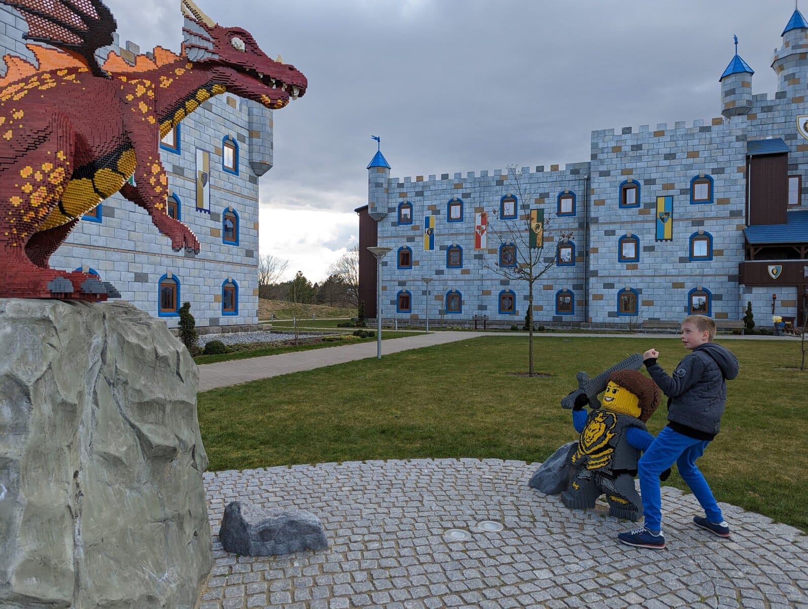 LEGOLAND Billund castle hotel, child playing next to a large LEGO sculpture