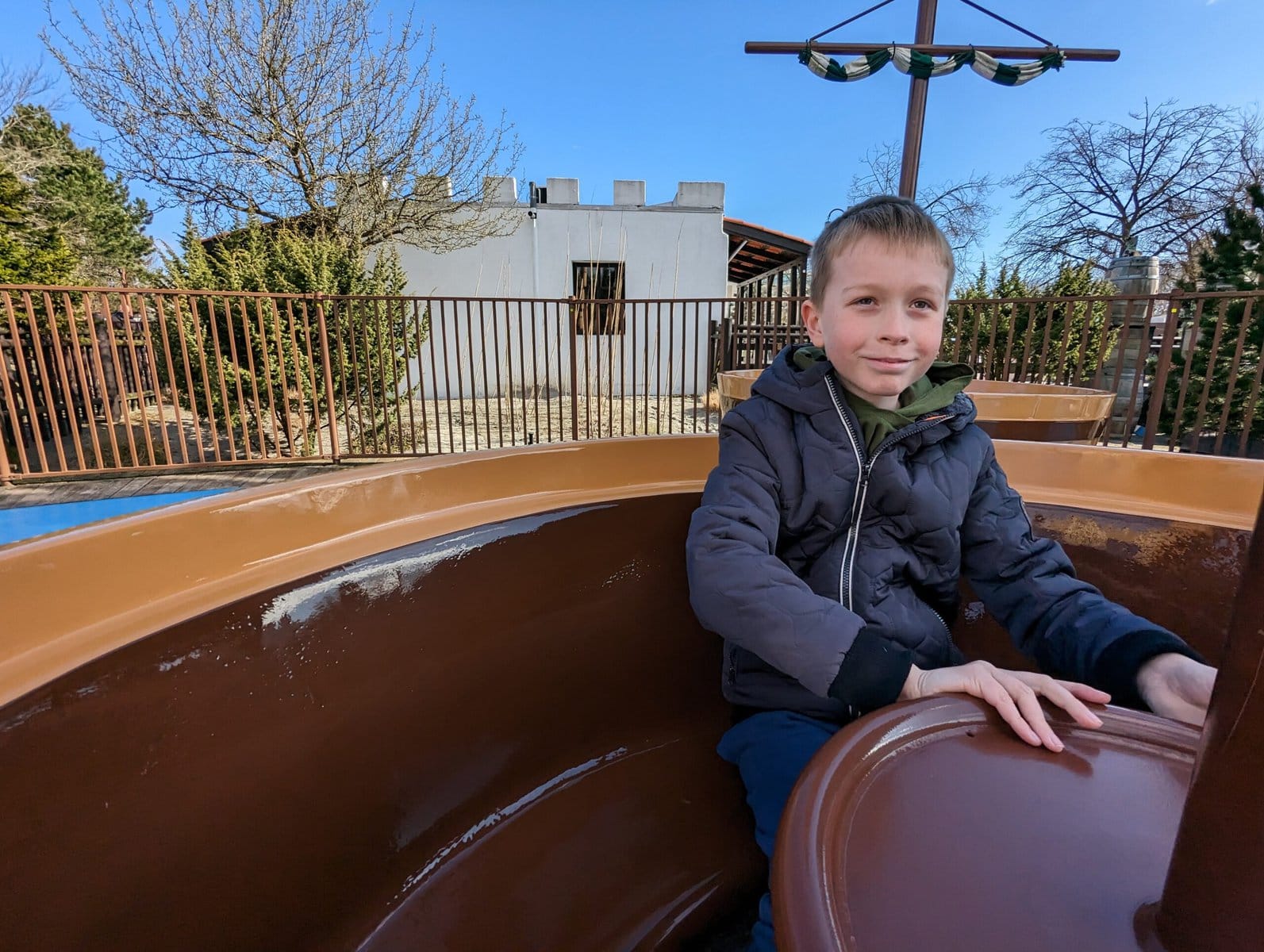 Boy sat in teacup on Boy in LEGOLAND Billund barrel ride