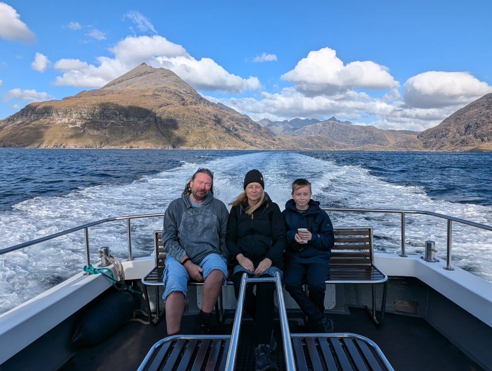 Family sat on a boat in Scotland