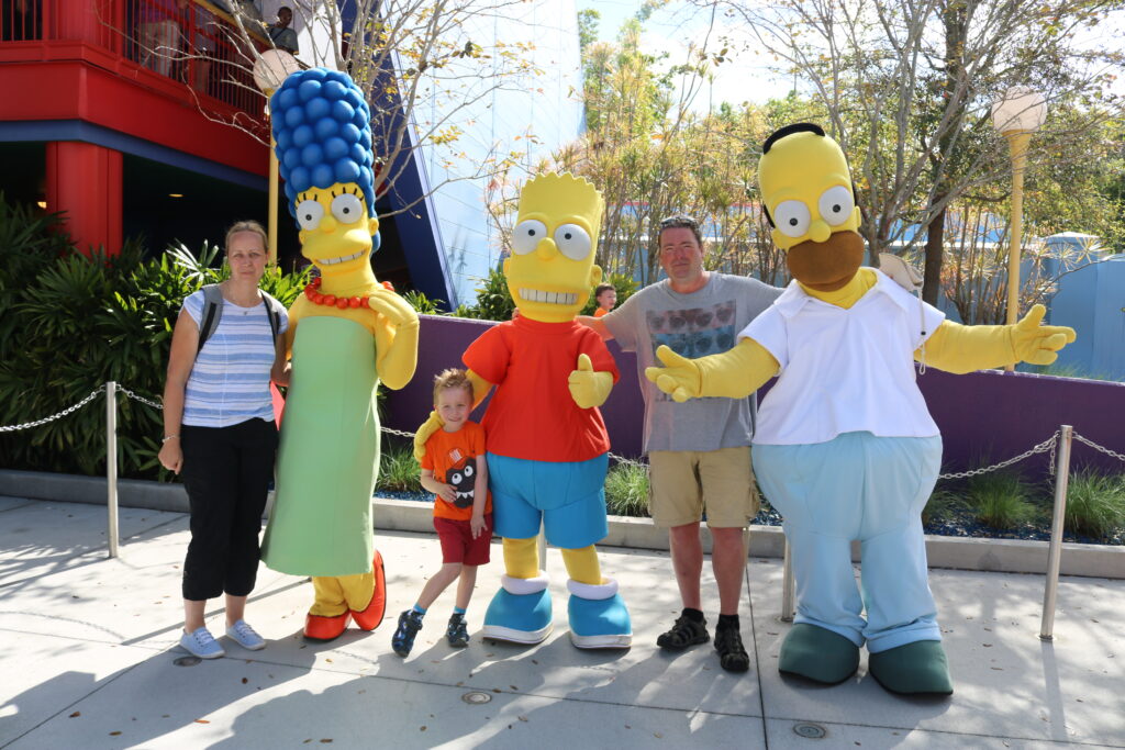 Family stood with Simpsons characters at Universal in Florida
