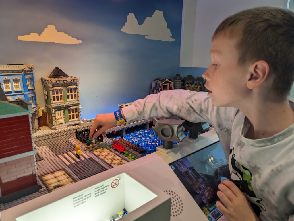Child playing with stop start motion in LEGO House Billund