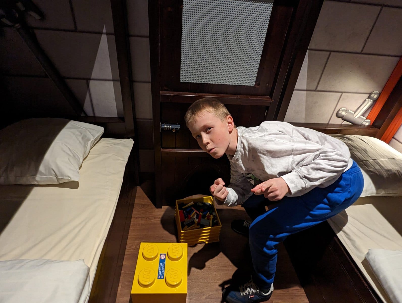 child posing in the child's bedroom area in the knights bedroom