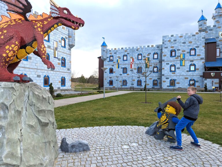 child playing in front of lego sculptures at the castle hotel legoland billund in Denmark