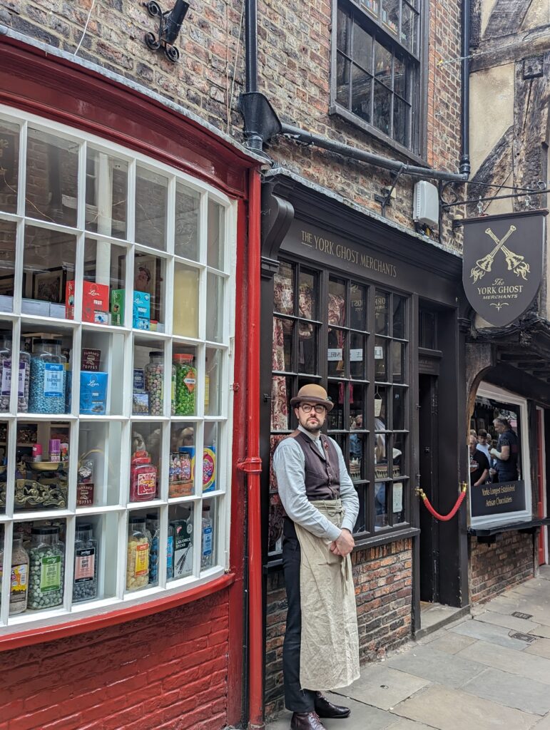 A man standing outside the Ghost Merchants in York, Shambles
