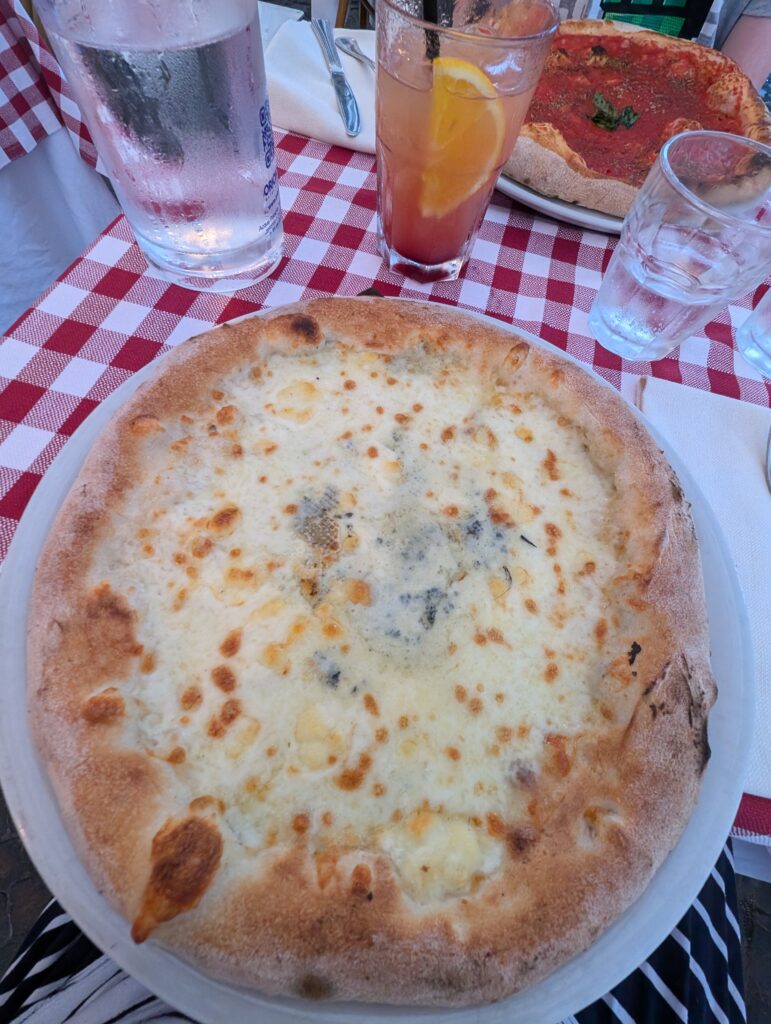 eating pizza in a square in Rome