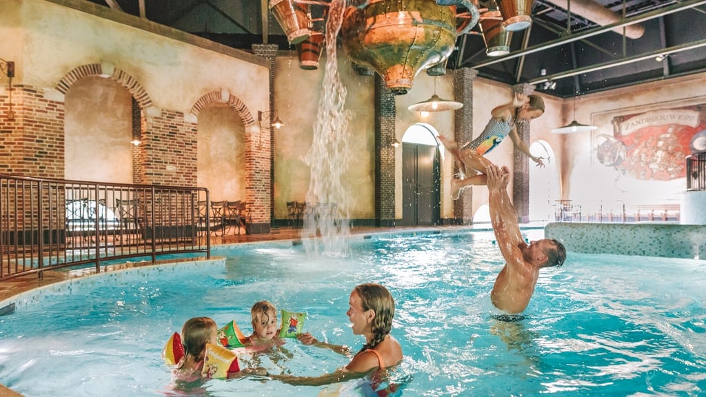 Family playing in the indoor pool