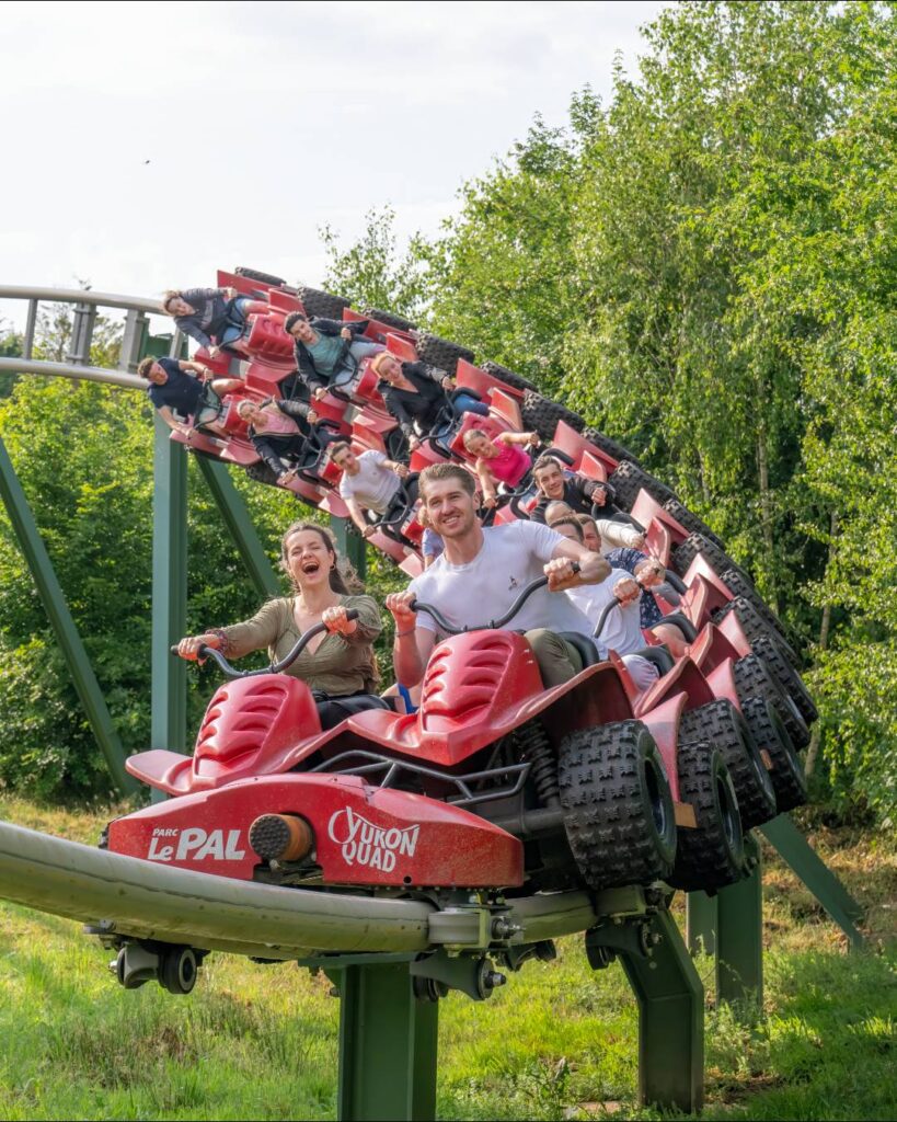 People on a red theme park ride at Le Pal in France