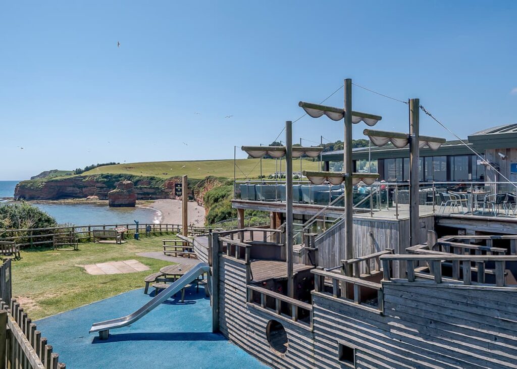 Outdoor wooden pirate ship with a view out to sea at Ladram Bay