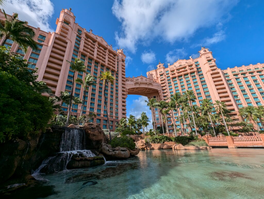 The inconic pink building of the Royal at Atlantis with water in front