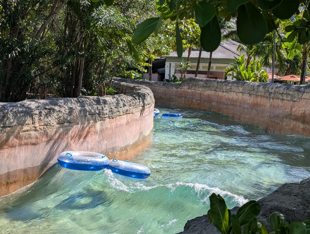 A wave with an inflatable ring riding it at the River Rapids Atlantis Bahamas