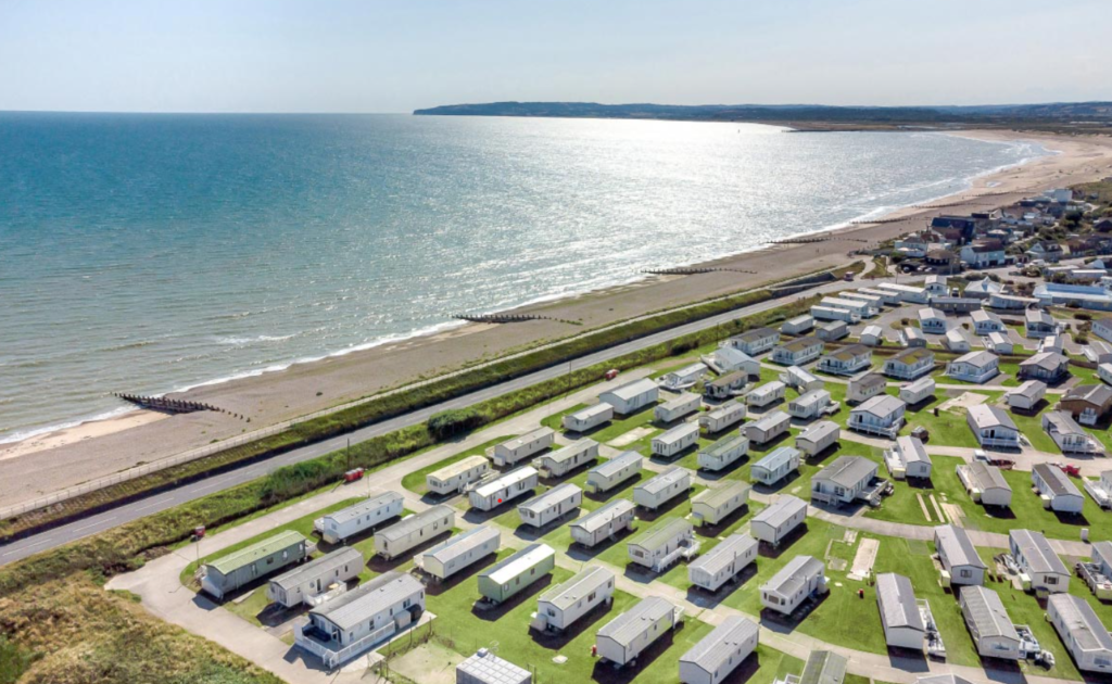 View of holiday lodges by the sea with a stretch of beach at Camber Sands