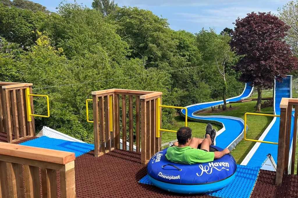 The outdoor tube slide with a person ready to go down the slope