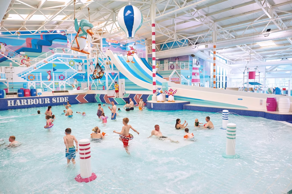 People playing and swimming in the indoor pool at Hafan Y Mor Haven