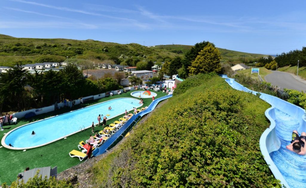 View looking down at the outdoor pool and slide at Holywell Bay Park Dean