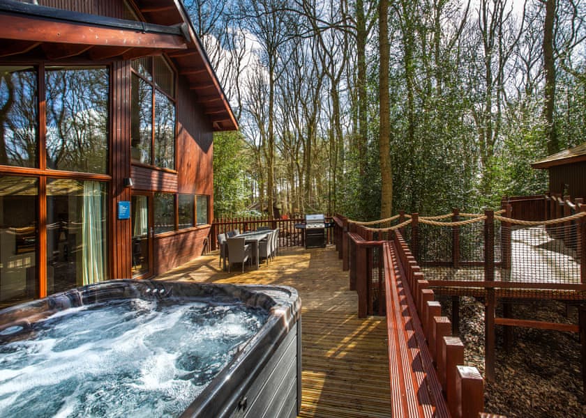 A lodge in a forest with an outdoor hot tub Sherwood Forest, Forest Holidays