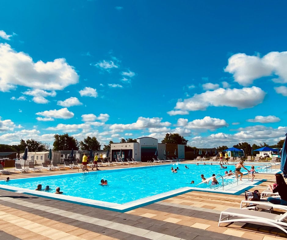 People swimming in the outdoor pool at Tattershall lakes