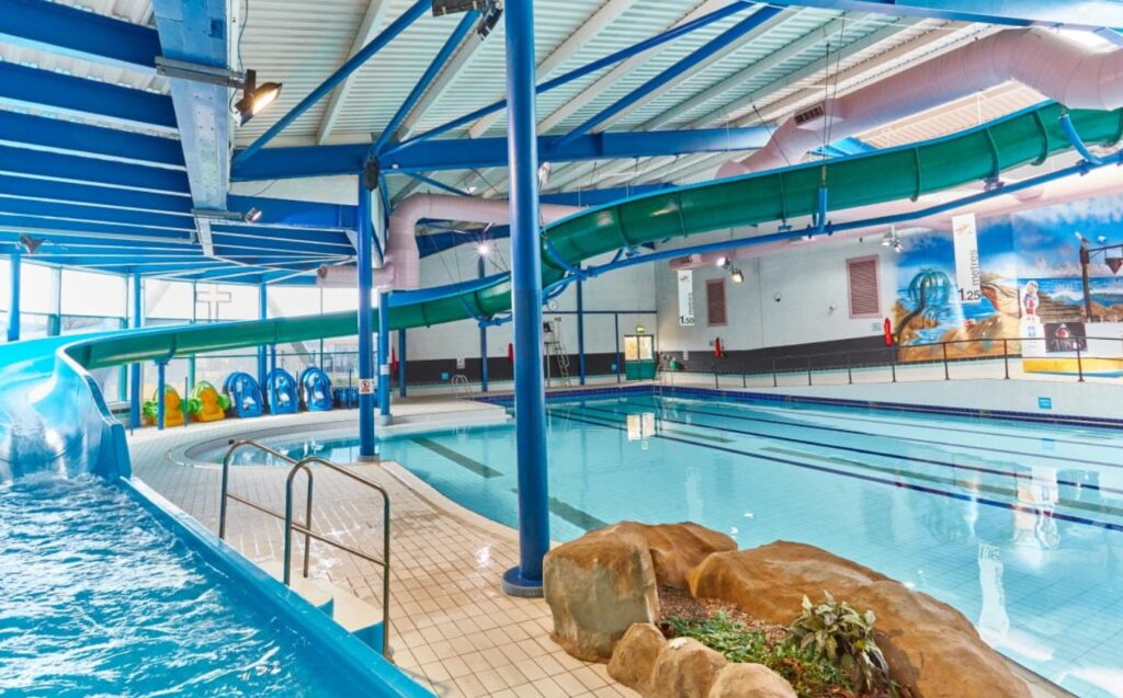 View of the indoor pool and water slide at Trecco Bay