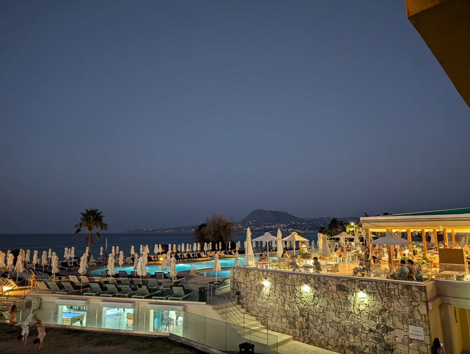 Kiani Beach Resort view of the beach pool at night